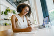 © Yaroslav Astakhov - female preparing project outline in cafe, woman focused on notetaking during productive cafe session