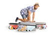 © Ljupco Smokovski - Man trying to close overpacked suitcases with clothes