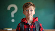 © miss irine - Young boy in red plaid shirt stands in classroom with backpack. Green blackboard behind large question mark drawn. Student looks thoughtful, curious. Child in school setting with books on desk.