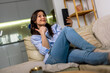 © Mediteraneo - Young woman on video call at home
