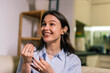 © Mediteraneo - Happy Young Deaf Woman Using Sign Language with Hearing Aid