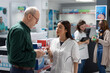 © DC Studio - Asian pharmacist offers cardiology care advice to old man during pharmacy visit, recommending cardio medicine for heart health, cholesterol control and blood pressure prevention support.