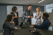 © Miljan Živković - Diverse business team collaborating in a modern office meeting