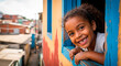 © Creative mind - Smiling Brazilian girl looking out of window for the concept of childhood happiness and community.