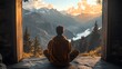© Crafted - A man sits in a meditative pose overlooking a stunning mountain vista, bathed in the warm glow of the setting sun.