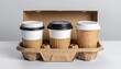 © andi - Coffee cups ready to go in a carrier, perfect for takeout or coffee delivery service