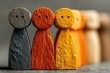 © Georgii - Line of colorful wooden figurines representing family and community in warm tones