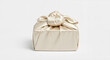 © daddy kang - 흰색 배경에 매듭으로 묶인 아이보리색 실크 보자기 포장 우아한 선물 상자