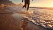 © CStock - A person joyfully running along the beach shore at sunset, vibrant waves splashing, capturing the essence of freedom.