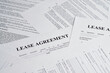 © Yauheni - Lease agreement forms. Concept of renting a home. Rental agreement paperwork. Top view. Document is mock-up