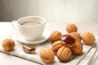 © New Africa - Delicious nut shaped cookies with boiled condensed milk and coffee on light table, closeup