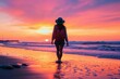 © Oleksandr Pashchenko - A woman walking on the beach at sunset