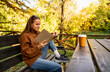 © Barillo_Images - Adult woman reading a book outdoors in city park, enjoying weekend leisure and digital detox lifestyle