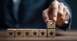 © mirna - Businessperson placing a checkmark block on a line of star blocks