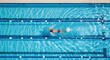 © Vasiliy - Aerial top view of a male swimmer training in a lap pool. Athletic man swimming the freestyle stroke. Sport, fitness, and competition concept