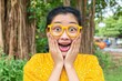 © Prazis Images - Overjoyed and Surprised Woman in Bright Yellow Glasses