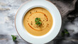 © kora studio - Creamy potato soup served in white bowl, garnished with herbs and drizzled with oil, creating warm and comforting dish perfect for any meal