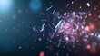 © Yuliia - Shattered glass fragments exploding in dramatic slow motion against dark blue background with orange and red light reflections.