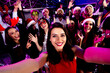 © deagreez - Happy crowd at a neon party dance in a festive nightclub scene with smiling friends dancing at a Christmas and New year celebration