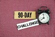 © Fauzi - Alarm clock and box of paper with the words 90-Day Challenge. Get into the best shape of your life with full 90 day workout programs. Lose Fat Know what to eat and why with 70+ healthy