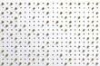 © Engineer Jahid - A white perforated board filled with many shiny golden circular studs arranged in a precise grid pattern