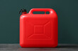 © Pixel-Shot - Red plastic canister on black table
