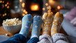 © Nataliya - Movie night on couch with popcorn and matching socks, cozy, family bonding, weekend, home entertainment, with copy space