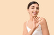 © Pixel-Shot - Young woman with vitamin E pill on beige background
