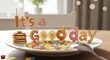 © Design Gallary - A plate of cereal and pancakes with the words its a good day spelled out in food on a table in a bright and cheerful setting