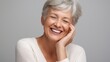 © abc123man - Elegant senior woman smiling with joyful expression showcasing happiness positive attitude and graceful aging in a professional portrait for wellness and lifestyle themes