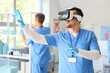 © Pixel-Shot - Male doctor using VR glasses in clinic