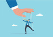 © Yeasin - Domination or manipulate by control puppet doll, marionette or exploitation, authority or boss micro management, dictator or slave concept, mystery hand control string on businessman puppet doll.