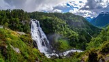 Mountain waterfall cascades into valley