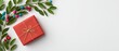 © thiwaporn - Elegant red gift box with ribbon on minimal white background for holiday presents and new year gifts