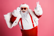 © deagreez - Joyful Santa in red suit with white fur trim posing playfully against pink background