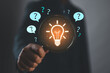 © Nirusmee - Businessman holding magnifying glass with glowing light bulb and question marks, representing problem solving, finding solutions, critical thinking, and innovative decision making.