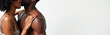 © miss irine - Black couple embracing on isolated white banner background with copy space. Woman with curly afro hair touches shirtless muscular boyfriend shoulder. Lovers in lingerie hug, showing love, affection.
