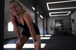 © .shock - Woman takes a break during workout session in modern gym setting with bright lighting and open space