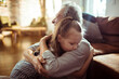 © Davor - Senior grandfather and child granddaughter share a comforting hug at home