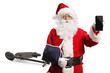 © Ljupco Smokovski - Santa Claus with arm injury and electric scooter showing a smartphone