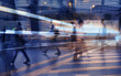 © kieferpix - business people crowd walking commuting in the city, street lights and motion blur abstract
