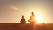 © kieferpix - Silhouette of a mother and child meditating together outdoors at sunset, symbolizing peace, mindfulness, bonding, and healthy living