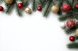 © ArtKom - Festive christmas border with pine branches and red ornaments on white background