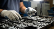 © Lexi - Worker sorting metal bolts and screws in workshop with tools