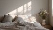 © sungedi - Soft morning light illuminates a neutral toned bedroom setting with layered linens and fresh flowers.