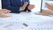 © volha_r - Business team clapping hands, celebrating financial success and achievement after a successful company presentation showing charts and data on a laptop screen