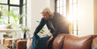 © peopleimages.com - Mature woman, cleaning and couch at house for real estate, tidy living room and interior comfort. Female realtor, arrange and cushion for furniture decoration, neat sofa and preparation for viewing