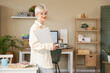 © Pixel-Shot - Young woman in eyeglasses with laptop in stylish office