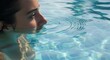 © mhmdyatt - Woman Relaxing in Swimming Pool Serene Water Reflection