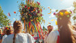 © Tatiana - A colorful maypole adorned with flowers and ribbons stands tall. A group of young women in traditional attire celebrate midsummer, wearing floral crowns.